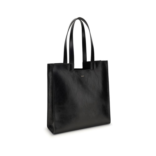 Black Calf Leather Bos Taurus Shoulder BagThe Bally Tote Bag is reimagined in a simple, minimalist style, featuring clean lines and a versatile shape suitable for any occasion. Made from calf leather with crêpe finishes, it features a gold-laminated logo,