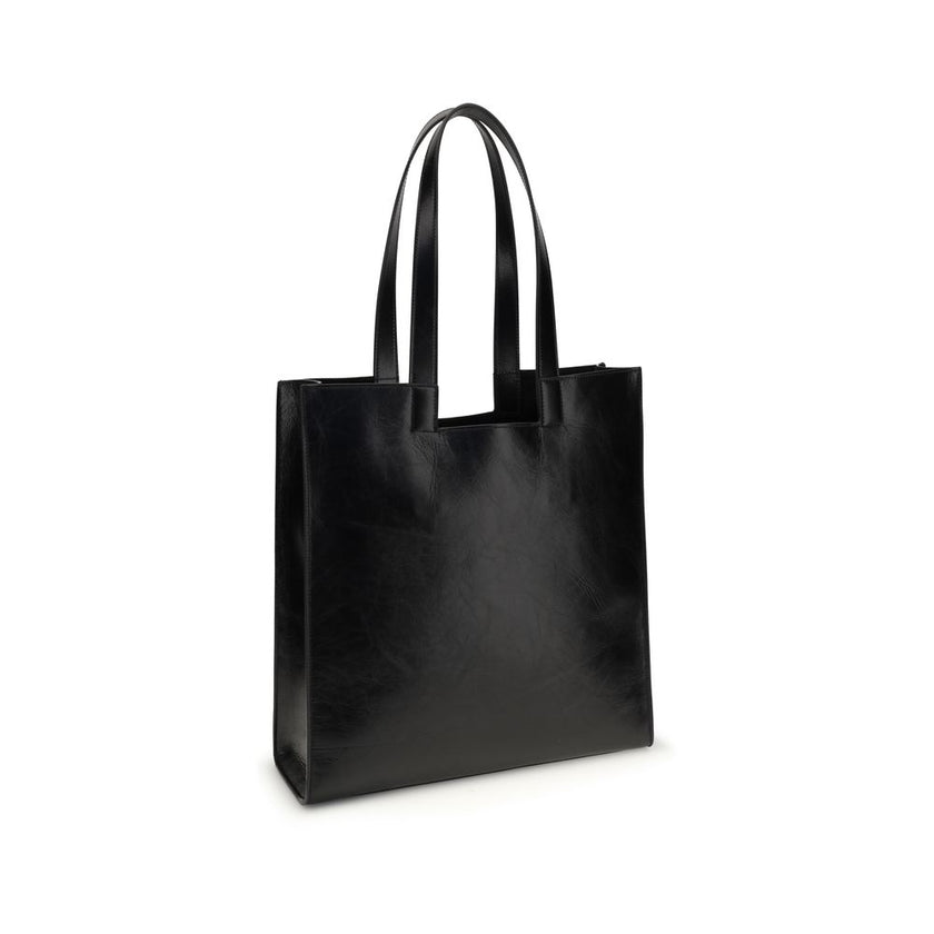 Black Calf Leather Bos Taurus Shoulder BagThe Bally Tote Bag is reimagined in a simple, minimalist style, featuring clean lines and a versatile shape suitable for any occasion. Made from calf leather with crêpe finishes, it features a gold-laminated logo,