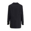Black Cashmere CoatThe Double-breasted Coat in wool and cashmere blend by Versace combines sartorial elegance with iconic details. The notched lapel, long sleeves, and front patch pockets enhance the coat’s classic lines, while the Safety Pin accessory an