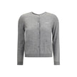 Gray Cashmere CardiganGucci’s cashmere Cardigan is a timeless garment, the epitome of elegance and comfort. Featuring a ribbed crew neck, hem and cuffs, it has a front button closure and two small patch pockets on the front. The iconic stitched signature