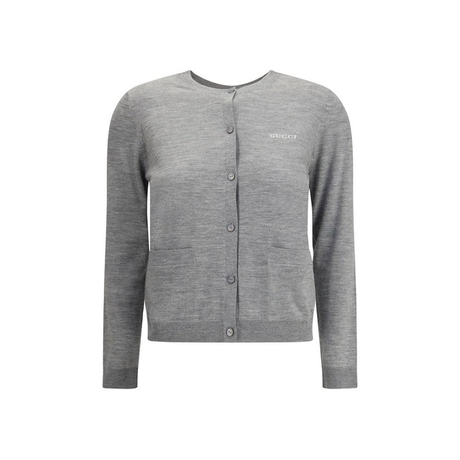 Gray Cashmere CardiganGucci’s cashmere Cardigan is a timeless garment, the epitome of elegance and comfort. Featuring a ribbed crew neck, hem and cuffs, it has a front button closure and two small patch pockets on the front. The iconic stitched signature