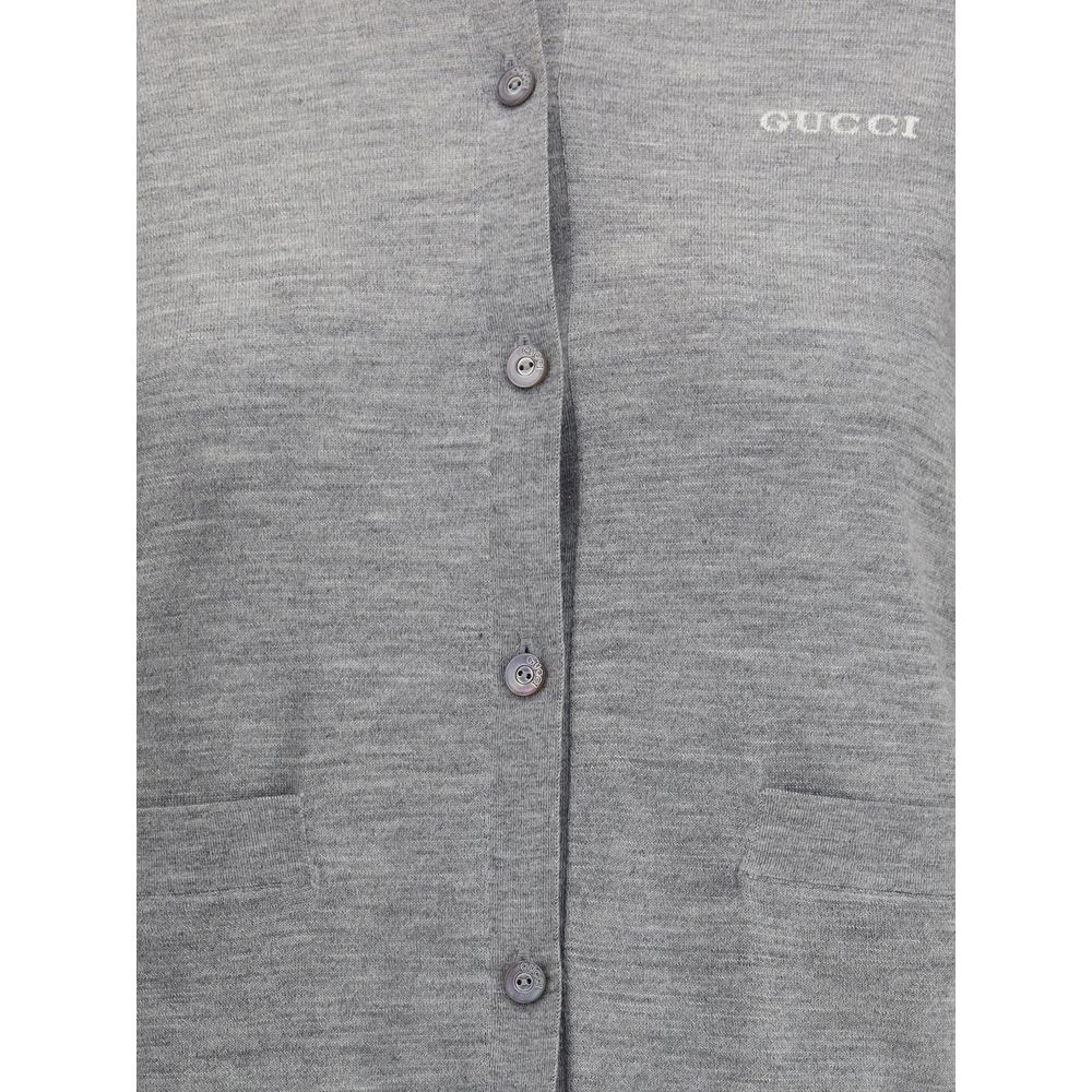 Gray Cashmere CardiganGucci’s cashmere Cardigan is a timeless garment, the epitome of elegance and comfort. Featuring a ribbed crew neck, hem and cuffs, it has a front button closure and two small patch pockets on the front. The iconic stitched signature
