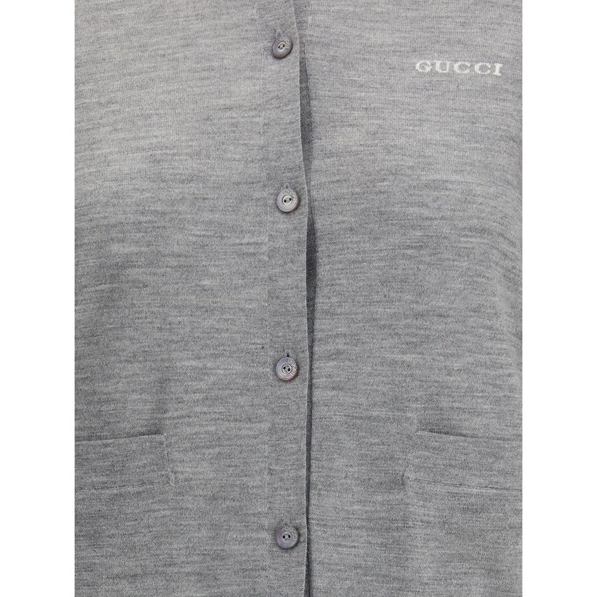 Gray Cashmere CardiganGucci’s cashmere Cardigan is a timeless garment, the epitome of elegance and comfort. Featuring a ribbed crew neck, hem and cuffs, it has a front button closure and two small patch pockets on the front. The iconic stitched signature