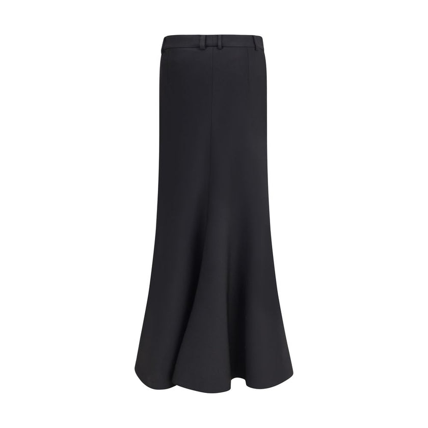 Black Fleece Wool Long SkirtBalenciaga’s virgin wool Godet skirt-trousers feature a mid-rise waist, front buttons, belt loops and inner pants for a versatile and refined style. Season: AW25 Fit: Regular Composition: 100% Fleece Wool MADE IN ITALYBlack Fle