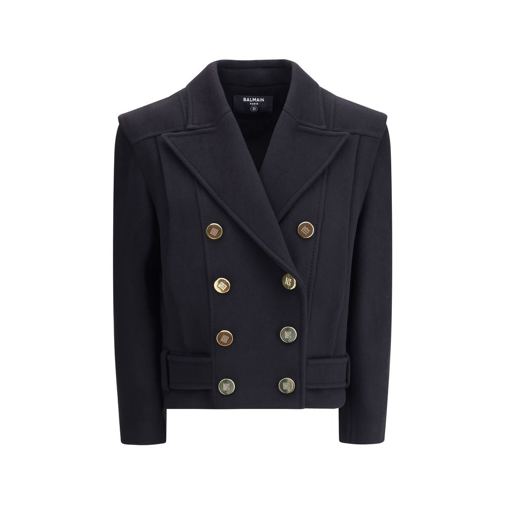 Black Wool CoatThe double-breasted coat by Balmain combines sophistication with contemporary modernity. Crafted from fine wool, its streamlined silhouette with broad shoulders and wide lapels flatters the figure, while the engraved gold buttons, decorativ