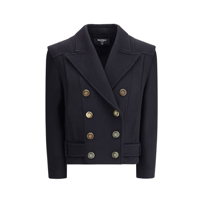 Black Wool CoatThe double-breasted coat by Balmain combines sophistication with contemporary modernity. Crafted from fine wool, its streamlined silhouette with broad shoulders and wide lapels flatters the figure, while the engraved gold buttons, decorativ
