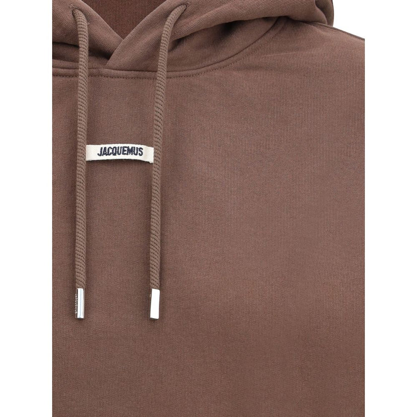 Logoed HoodieCotton Hoodie by Jacquemus, featuring an adjustable drawstring hood for a custom fit. Featuring a logo patch on the front, ribbed cuffs and hem for a finishing touch. The slim fit flatters the silhouette, combining comfort and contemporary st