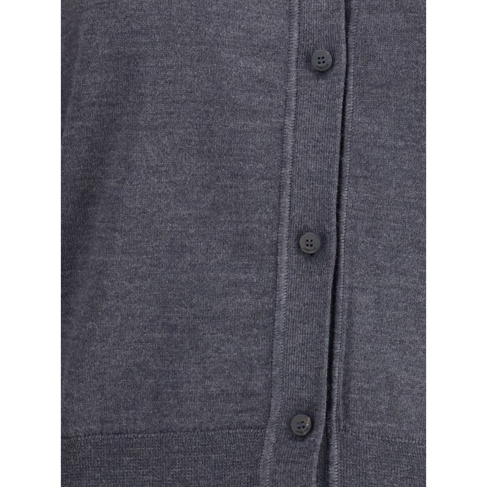 Merino wool CardiganMerino wool Cardigan by Jacquemus combines elegance and comfort with a V-neckline and front button closure. Finished with a ribbed hem and cuffs, it is embellished with an embroidered logo on the back for a distinctive, modern touch. S