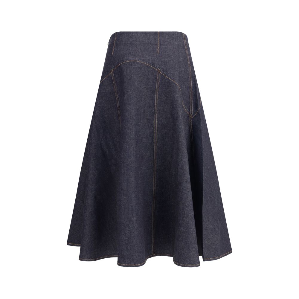 Blue Cotton Midi SkirtThe denim midi Skirt by Jacquemus is a flared design with contrast stitching that enhances its structure. Featuring ‘J’ embroidery on the side and a side zipper closure, it combines a distinctive touch with a versatile, contemporary