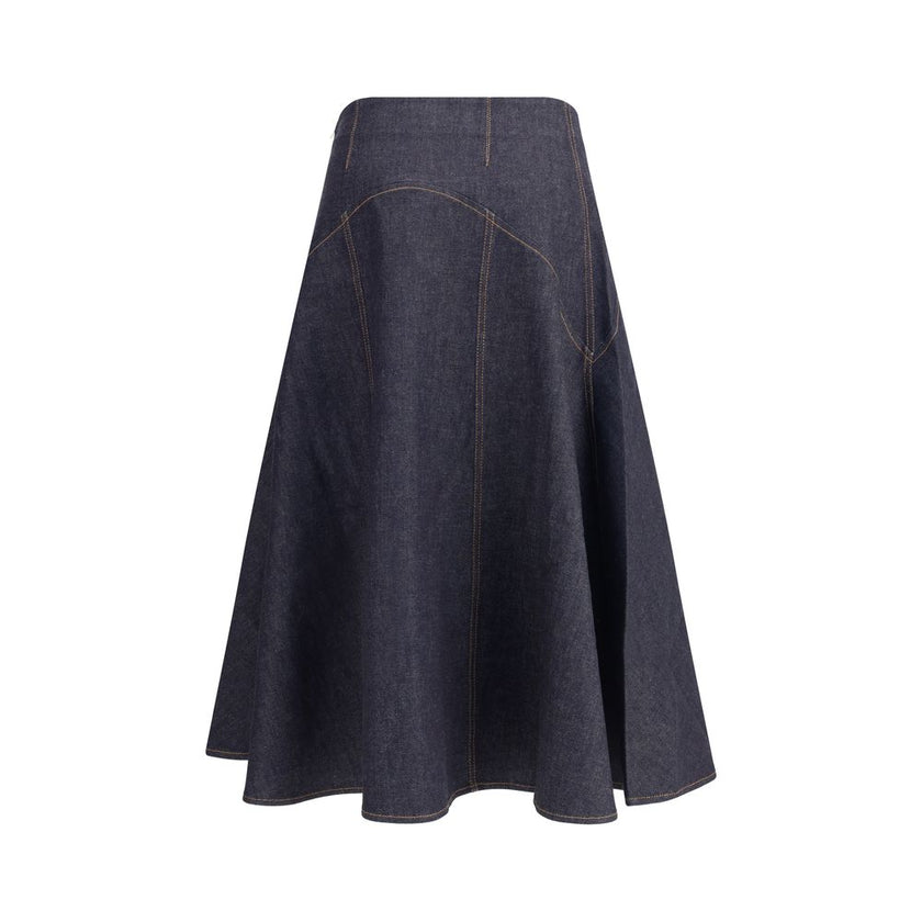 Blue Cotton Midi SkirtThe denim midi Skirt by Jacquemus is a flared design with contrast stitching that enhances its structure. Featuring ‘J’ embroidery on the side and a side zipper closure, it combines a distinctive touch with a versatile, contemporary