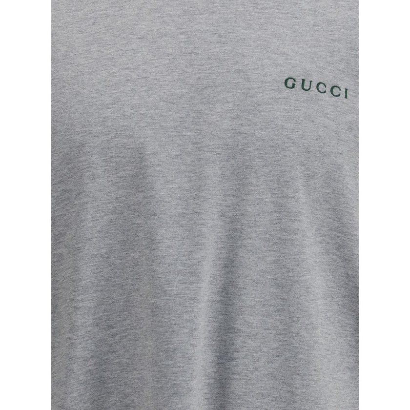 Gray Cotton T-ShirtLight grey melange cotton T-shirt with Gucci embroidery on the chest and contrasting Web details. Season: AW25 Fit: Regular Composition: 100% Cotton MADE IN ITALYGray Cotton T-Shirt${tagsGucciAulae Cotton T-shirt with embroidered logo G