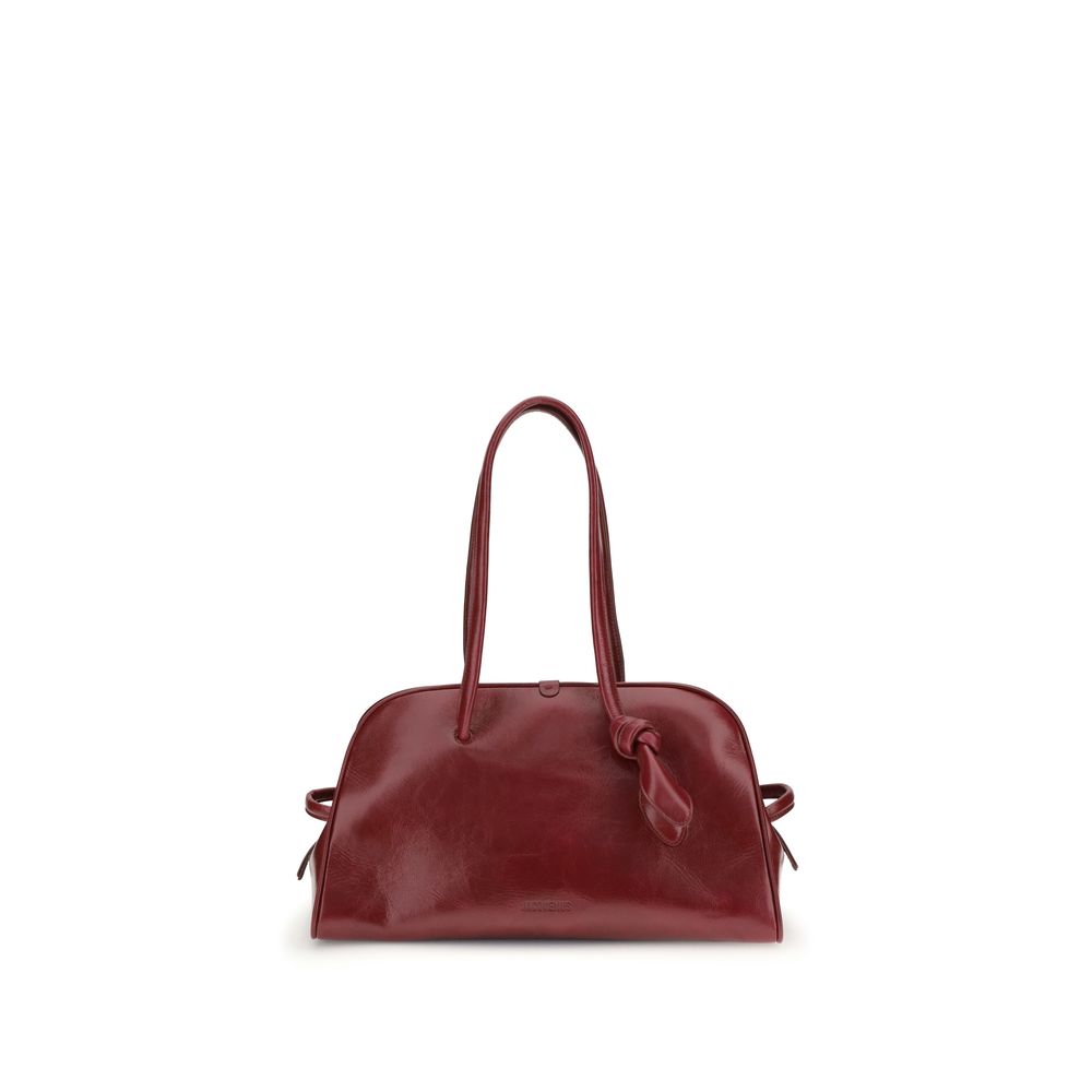 Red Calf Leather Bos Taurus Shoulder BagThe Bowling Bag by Jacquemus in glossy leather with a vintage finish is a refined and contemporary accessory. The double-zip closure and coordinated leather tubular handles, enhanced by an elegant knotted detail, hi