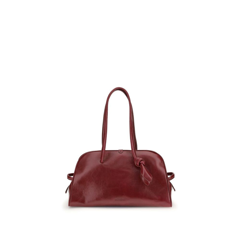 Red Calf Leather Bos Taurus Shoulder BagThe Bowling Bag by Jacquemus in glossy leather with a vintage finish is a refined and contemporary accessory. The double-zip closure and coordinated leather tubular handles, enhanced by an elegant knotted detail, hi