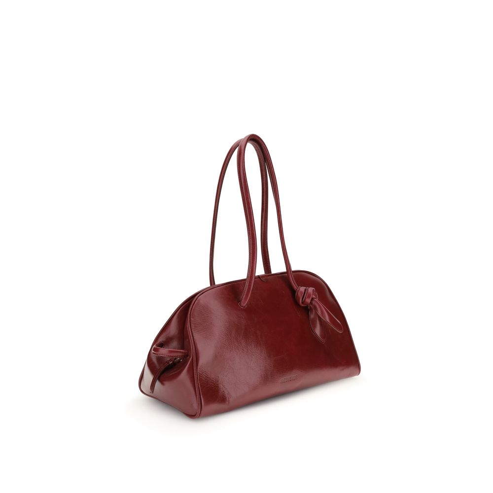 Red Calf Leather Bos Taurus Shoulder BagThe Bowling Bag by Jacquemus in glossy leather with a vintage finish is a refined and contemporary accessory. The double-zip closure and coordinated leather tubular handles, enhanced by an elegant knotted detail, hi