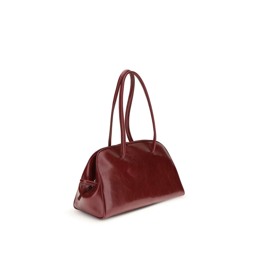 Red Calf Leather Bos Taurus Shoulder BagThe Bowling Bag by Jacquemus in glossy leather with a vintage finish is a refined and contemporary accessory. The double-zip closure and coordinated leather tubular handles, enhanced by an elegant knotted detail, hi