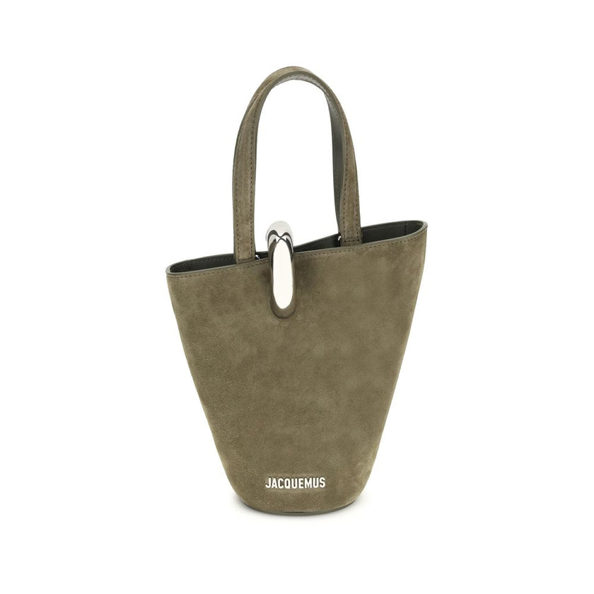 La Bambola Bucket BagThe La Bambola Bucket Bag by Jacquemus combines original design and functionality. Made from soft suede leather, it features double handles and a removable shoulder strap for versatile carrying options. The silver-tone metal ring clos