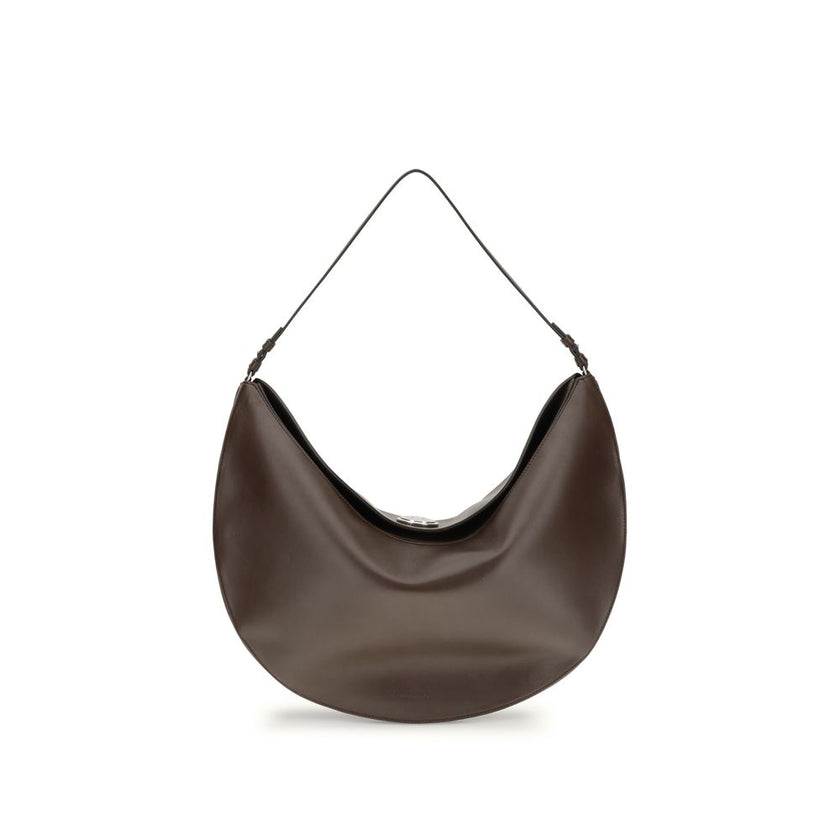 Brown Calf Leather Bos Taurus Shoulder BagThe Ovalo Bag by Jacquemus is an elegant large hobo bag crafted from smooth leather, featuring a slim shoulder strap for easy carrying. The flap with a large engraved snap button ensures secure closure, while the