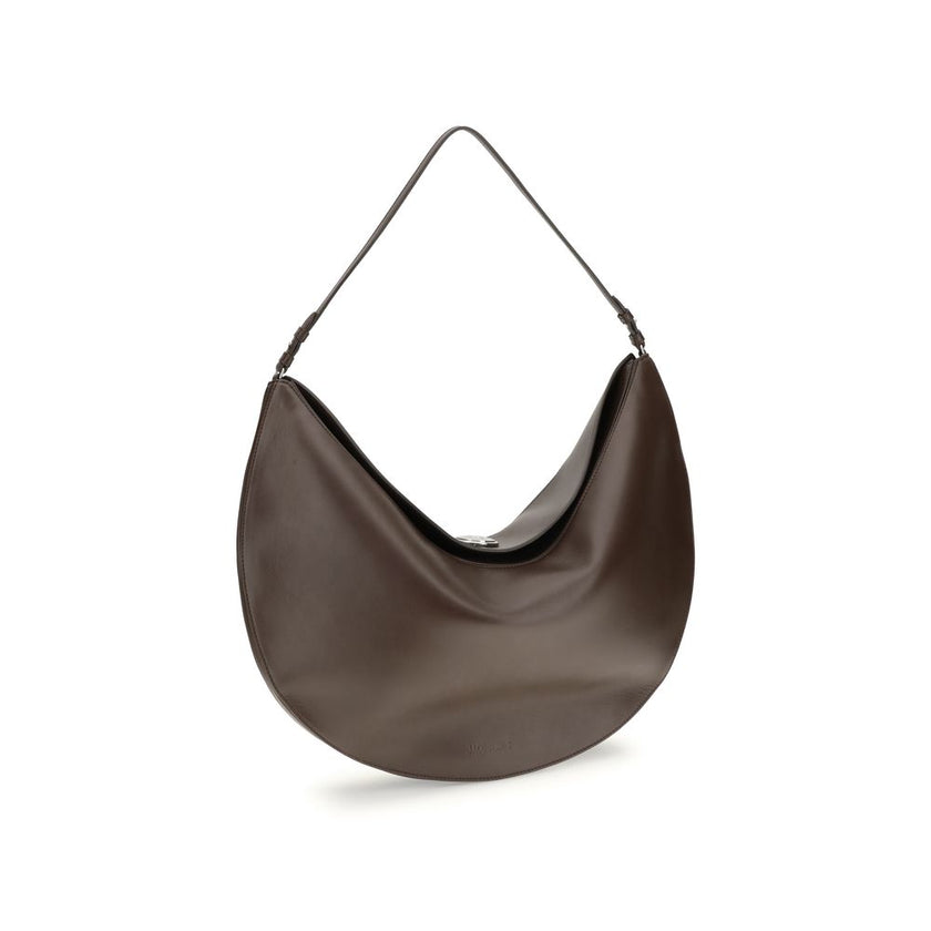 Brown Calf Leather Bos Taurus Shoulder BagThe Ovalo Bag by Jacquemus is an elegant large hobo bag crafted from smooth leather, featuring a slim shoulder strap for easy carrying. The flap with a large engraved snap button ensures secure closure, while the