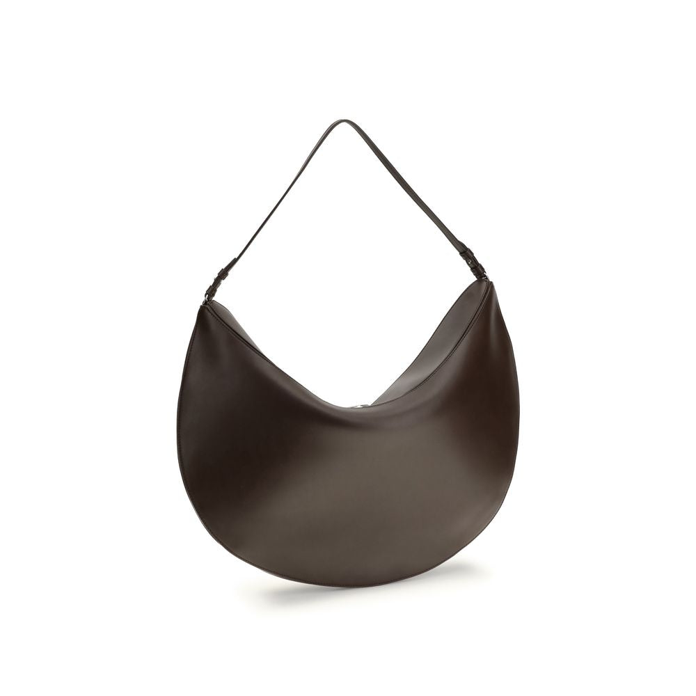 Brown Calf Leather Bos Taurus Shoulder BagThe Ovalo Bag by Jacquemus is an elegant large hobo bag crafted from smooth leather, featuring a slim shoulder strap for easy carrying. The flap with a large engraved snap button ensures secure closure, while the