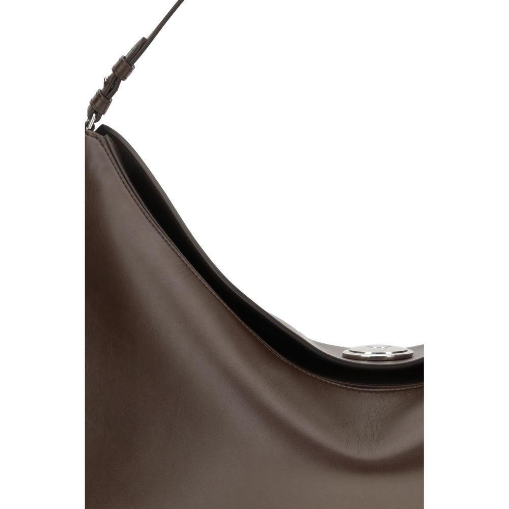 Brown Calf Leather Bos Taurus Shoulder BagThe Ovalo Bag by Jacquemus is an elegant large hobo bag crafted from smooth leather, featuring a slim shoulder strap for easy carrying. The flap with a large engraved snap button ensures secure closure, while the