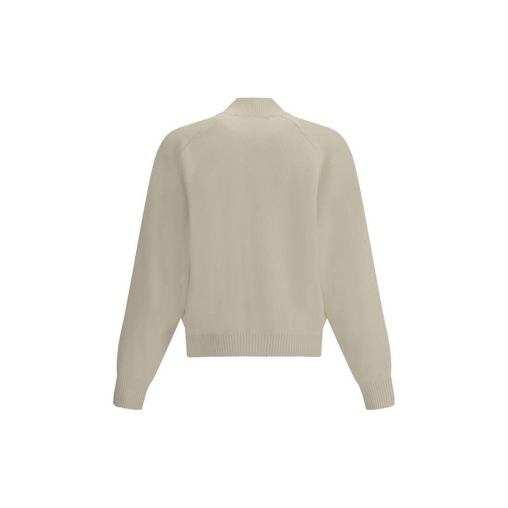 White Fleece Wool CardiganThe Virgin Wool Cardigan by Jacquemus combines elegance and comfort, featuring front buttons that emphasize its refined silhouette. The long sleeves and ribbed trims add a touch of classic style, while the embroidered detail on t