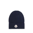 Blue Wool BeanieThe Moncler wool and cashmere hat is crafted from a soft blend of blue virgin wool and cashmere, using Italian craftsmanship. One size fits all, it guarantees warmth, comfort, and a touch of elegance. Season: AW25 Composition: 70% Wool 30%