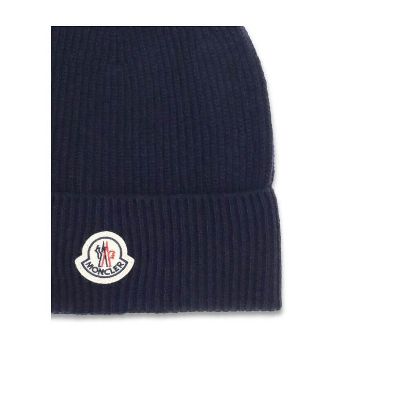 Blue Wool BeanieThe Moncler wool and cashmere hat is crafted from a soft blend of blue virgin wool and cashmere, using Italian craftsmanship. One size fits all, it guarantees warmth, comfort, and a touch of elegance. Season: AW25 Composition: 70% Wool 30%