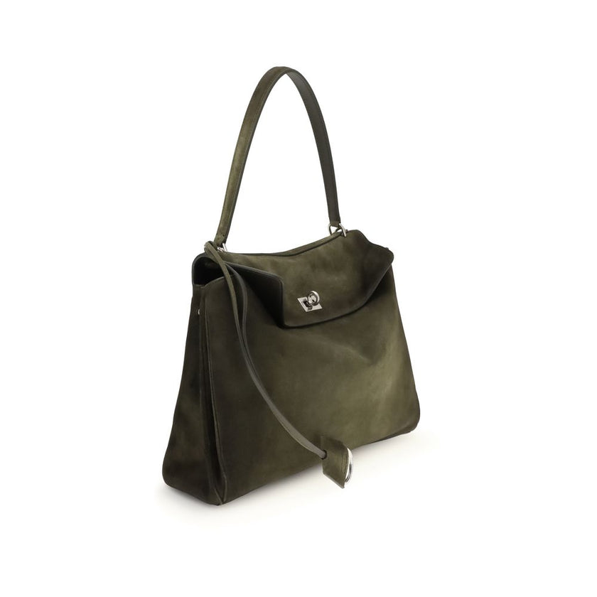 Green Calf Leather Bos Taurus Shoulder BagThe Medium Rodeo Bag by Balenciaga blends sophistication and practicality with its combination of waxed suede calfskin and smooth leather. It features a top handle and a detachable shoulder strap for versatile car