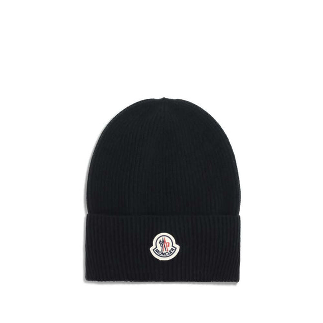 Wool and cashmere HatThe Moncler wool and cashmere hat is crafted from a soft blend of blue virgin wool and cashmere, using Italian craftsmanship. One size fits all, it guarantees warmth, comfort, and a touch of elegance. Season: AW25 Composition: GENERAL