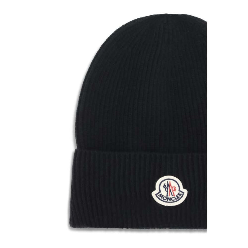 Wool and cashmere HatThe Moncler wool and cashmere hat is crafted from a soft blend of blue virgin wool and cashmere, using Italian craftsmanship. One size fits all, it guarantees warmth, comfort, and a touch of elegance. Season: AW25 Composition: GENERAL
