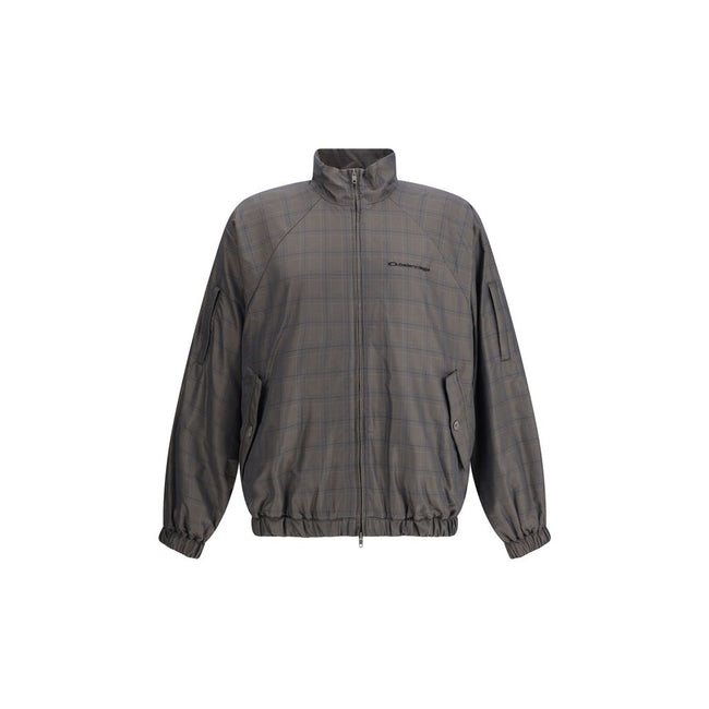 Brown Cotton Shell JacketThis Balenciaga Jacket is crafted from checked Cotton and Linen, featuring a high collar and a double-slider zip closure. With long sleeves, two slash pockets, and a drawstring waist, it is finished with embroidered Balenciaga log