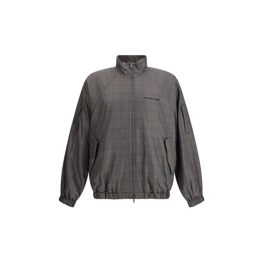 Brown Cotton Shell JacketThis Balenciaga Jacket is crafted from checked Cotton and Linen, featuring a high collar and a double-slider zip closure. With long sleeves, two slash pockets, and a drawstring waist, it is finished with embroidered Balenciaga log