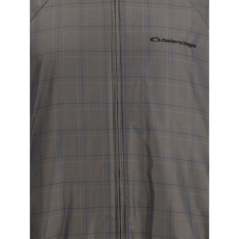 Brown Cotton Shell JacketThis Balenciaga Jacket is crafted from checked Cotton and Linen, featuring a high collar and a double-slider zip closure. With long sleeves, two slash pockets, and a drawstring waist, it is finished with embroidered Balenciaga log