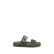 FF fabric sandalThe FF fabric Sandal by Fendi is a flat slide featuring a double strap with a decorative FF Baguette buckle. Crafted in jacquard fabric with the iconic FF pattern and black nappa leather details, it is finished with gold-tone metal hardwar