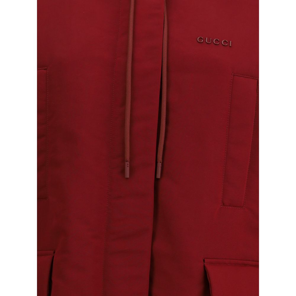 Bordeaux Polyester Shell JacketThe Gucci Red Polyester faille Jacket combines functionality with contemporary style. Featuring a fixed hood with zip and drawcord, four front pockets, adjustable elastic hem, and padding, it provides comfort and protection.
