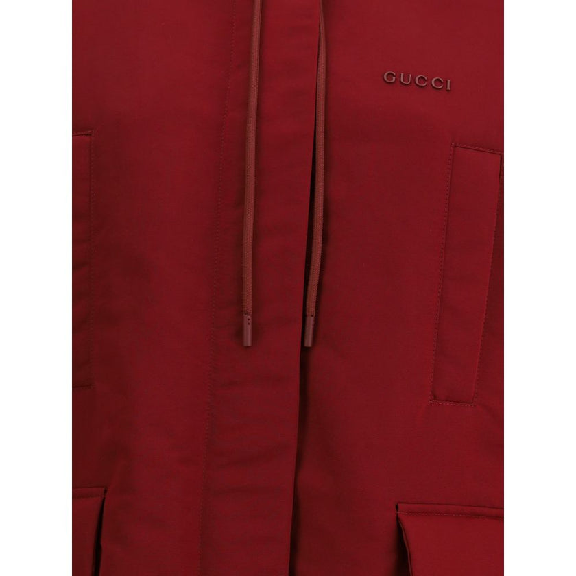Bordeaux Polyester Shell JacketThe Gucci Red Polyester faille Jacket combines functionality with contemporary style. Featuring a fixed hood with zip and drawcord, four front pockets, adjustable elastic hem, and padding, it provides comfort and protection.