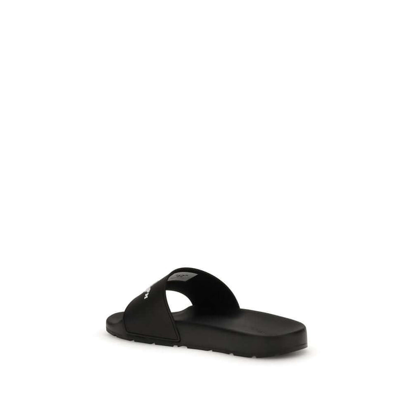 Black Polyethylene SandalsThe Slides by Off-White are a casual and distinctive accessory, designed for an urban and contemporary style. They feature a minimalist silhouette with a wide, comfortable strap, highlighted by the contrasting white Off-White log