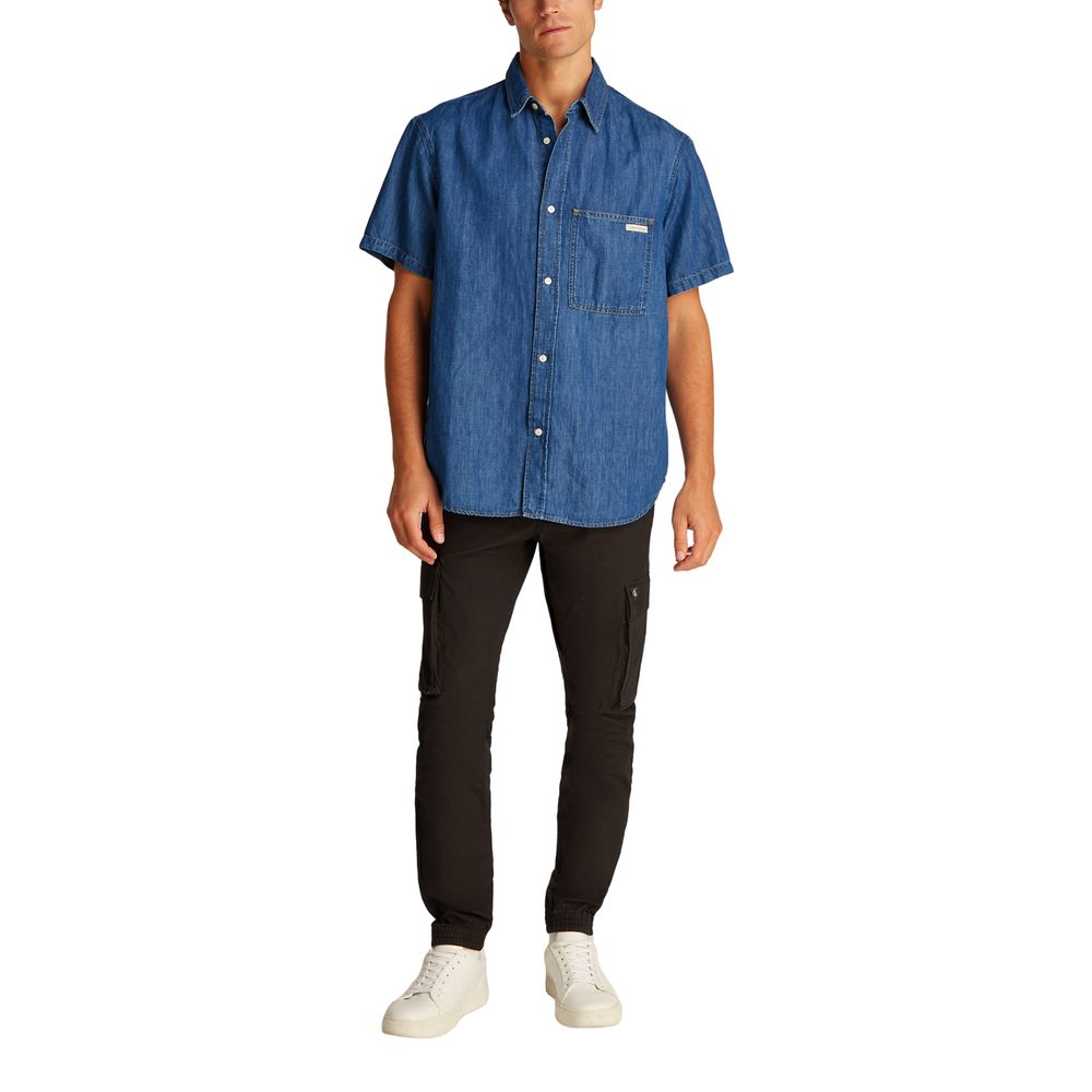 Blue Cotton ShirtDiscover the Calvin Klein Jeans REGULAR SS DENIM J30J327178 long-sleeve shirt for men, a versatile and stylish piece of clothing. Made with an innovative blend of materials, this shirt features 47% cotton, 20% recycled cotton, 19% linen,