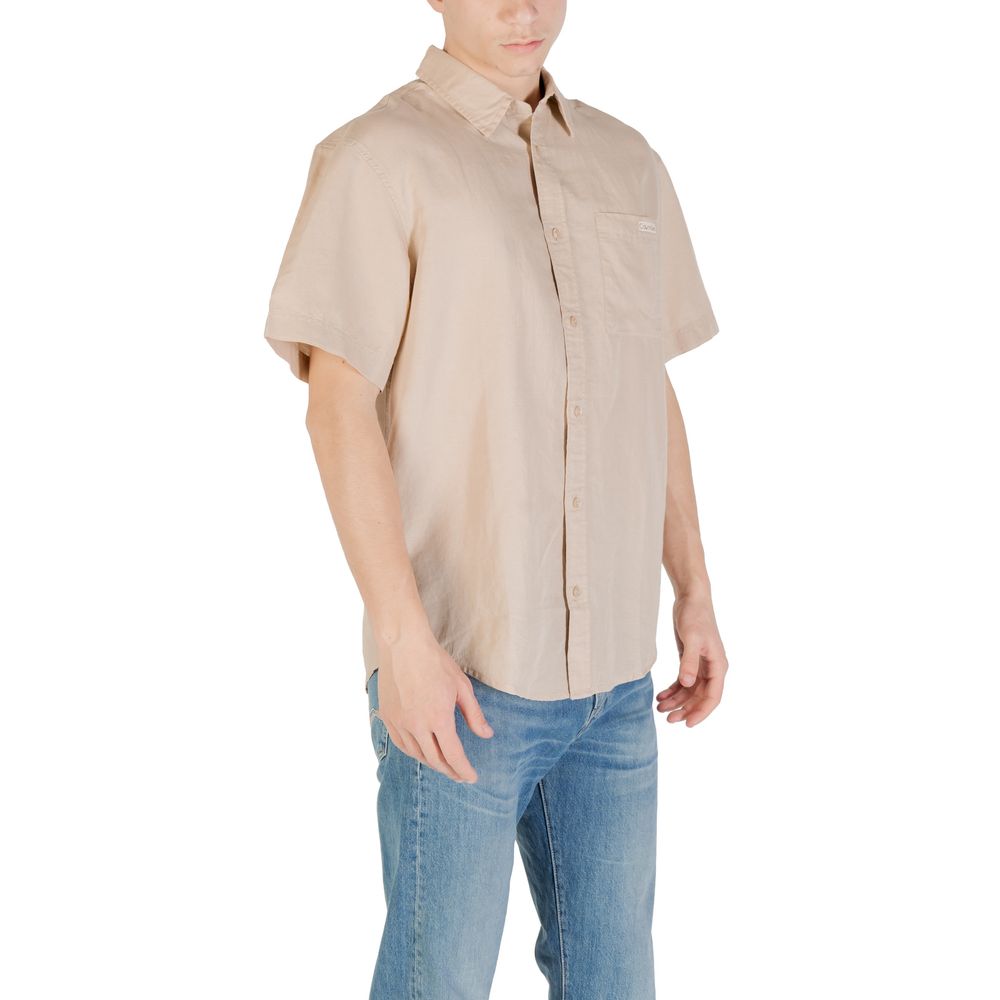 Beige Linen Shortsleeve ShirtDiscover the Calvin Klein Jeans LINEN COTTON S/S J30J327296 short-sleeve shirt for men, an essential piece for your summer wardrobe. Made with a blend of 58% linen and 42% cotton, this shirt offers unique freshness and breatha