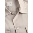 Beige Lyocell ShirtDiscover the long-sleeve men’s shirt by Calvin Klein, a clothing piece that combines elegance and practicality. Made from a refined blend of 51% Lyocell, 47% Linen, and 2% Elastane, this shirt offers exceptional comfort and a perfect fi