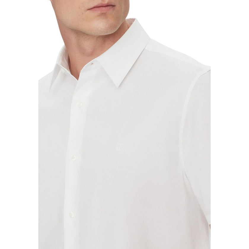 White Organic Cotton Shortsleeve ShirtDiscover the short-sleeve menâs shirt by Calvin Klein, an essential piece for your summer wardrobe. Made from a blend of 60% organic cotton, 36% cotton, and 4% elastane/lycra, this shirt provides a comfortable fit a