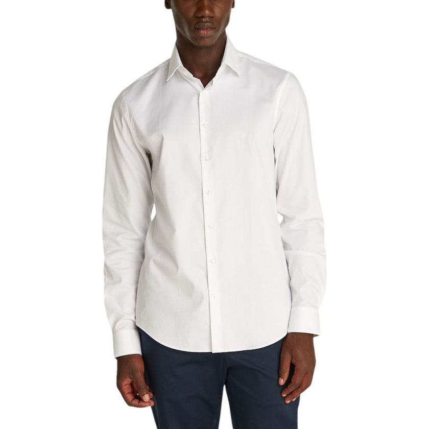 White Cotton ShirtDiscover the Calvin Klein TONAL STRUCTURE long-sleeve shirt for men, an essential piece for the male wardrobe. Made with a careful blend of 52% cotton, 44% polyester, and 4% elastane/lycra, this shirt offers a comfortable fit and a soft