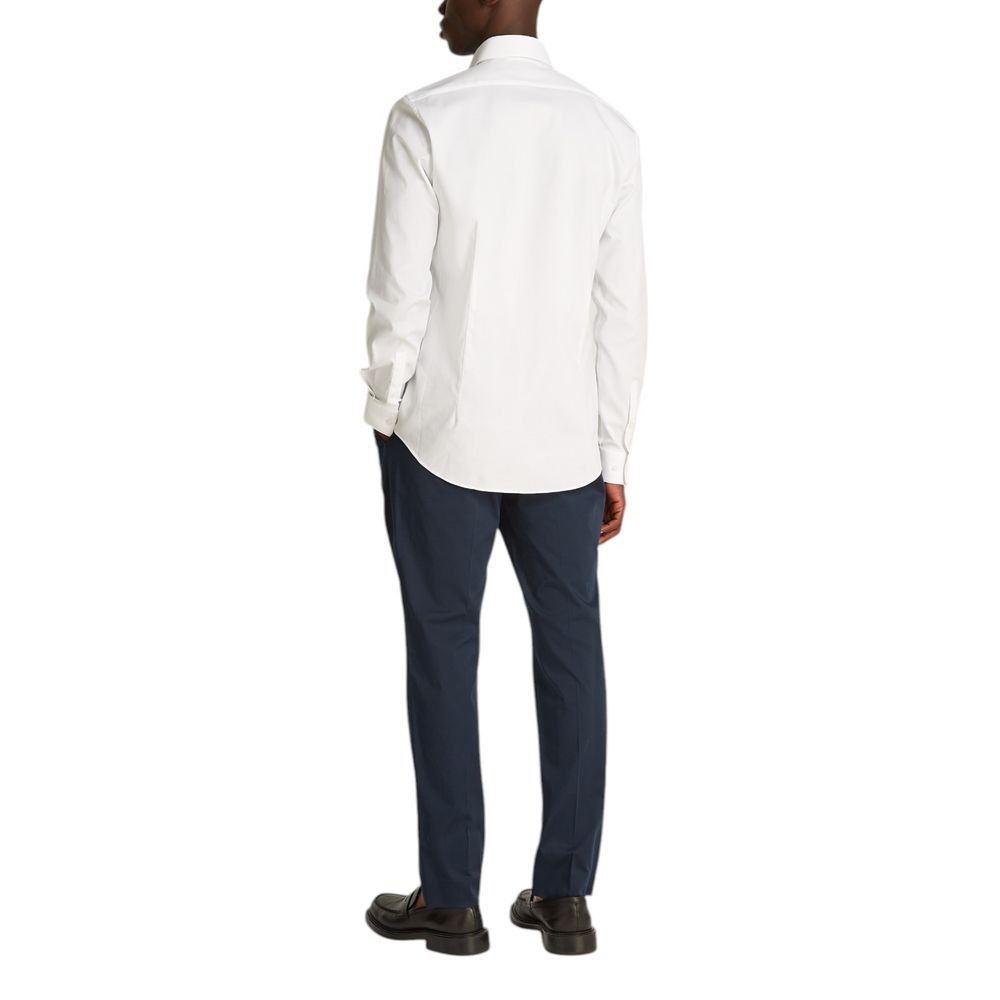 White Cotton ShirtDiscover the Calvin Klein TONAL STRUCTURE long-sleeve shirt for men, an essential piece for the male wardrobe. Made with a careful blend of 52% cotton, 44% polyester, and 4% elastane/lycra, this shirt offers a comfortable fit and a soft