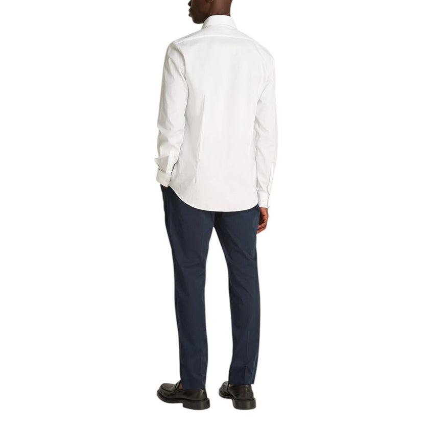 White Cotton ShirtDiscover the Calvin Klein TONAL STRUCTURE long-sleeve shirt for men, an essential piece for the male wardrobe. Made with a careful blend of 52% cotton, 44% polyester, and 4% elastane/lycra, this shirt offers a comfortable fit and a soft