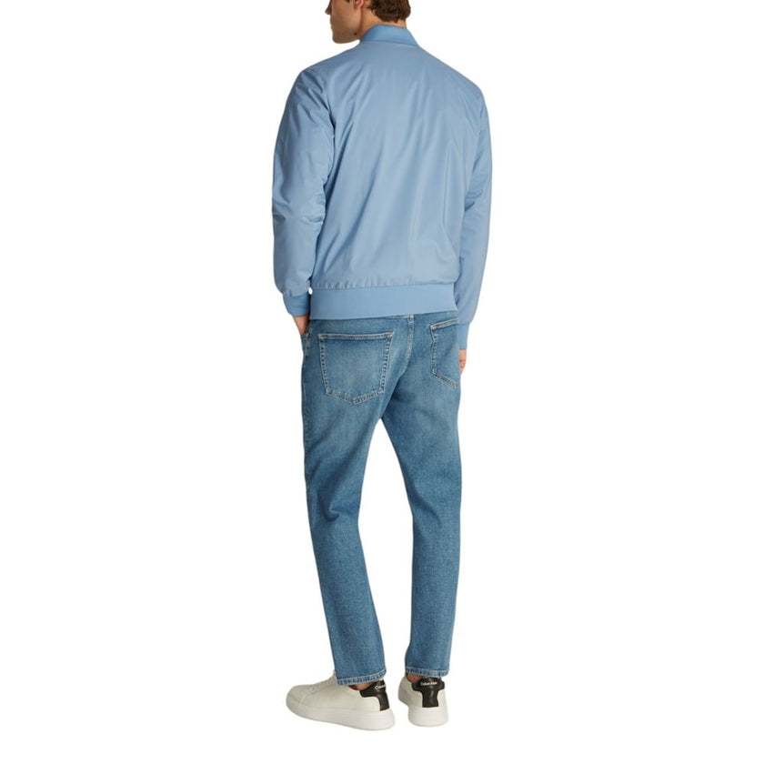 Light Blue Recycled Polyester Jackets & CoatDiscover the Matte Bomber jacket by Calvin Klein, an essential piece for the men’s wardrobe. Made from 100% recycled polyester, this bomber combines sustainability with contemporary style. The minimalist design