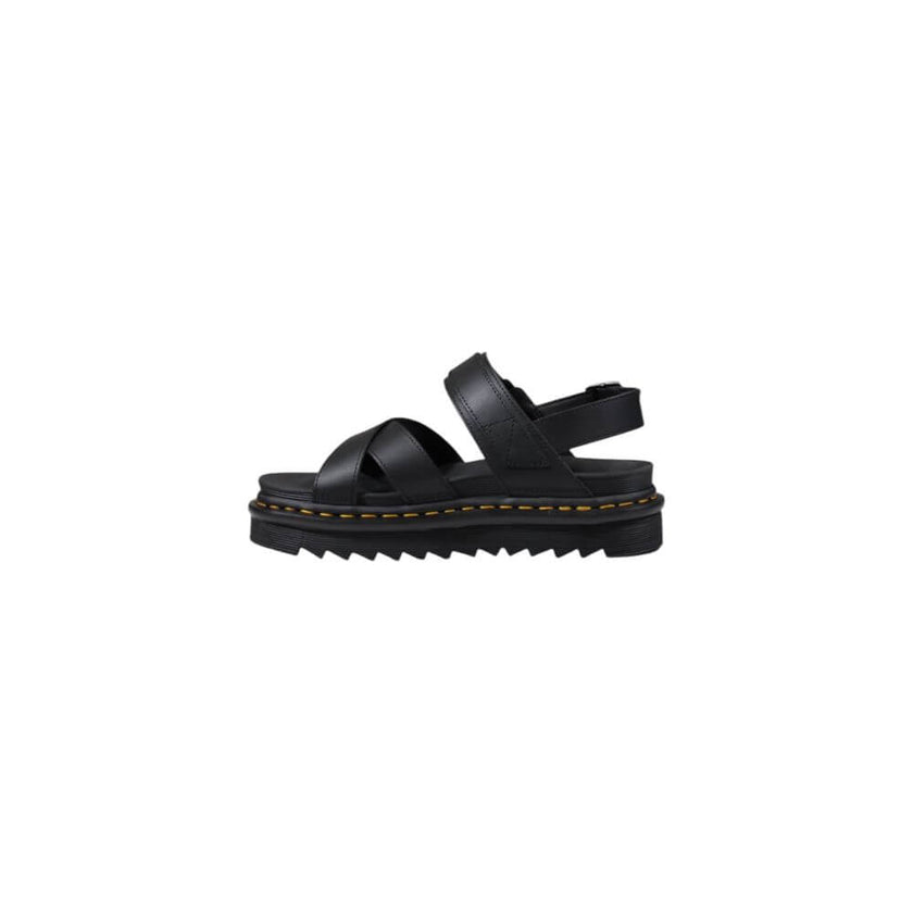 Black Leather SandalThe Dr. Martens Voss II Athena 31558001 women’s sandals are made from 100% high-quality leather, ensuring durability and longevity. This model combines style and comfort, making them perfect for any summer occasion. The rubber sole pro