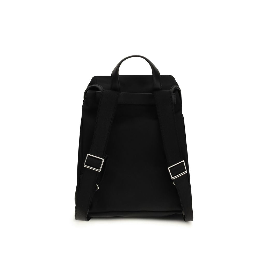 Black Nylon BackpackThe New Trick Backpack by Moncler is designed for everyday use, combining functionality and style. Made from water-repellent recycled nylon with a nylon lining, it features leather finishes and handle, adjustable shoulder straps, and a