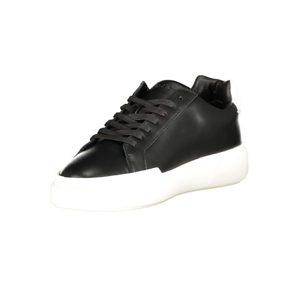 Black Leather Men's SneakerElevate your athletic ensemble with Calvin Klein’s latest offering—sleek sports shoes designed to turn heads and enhance performance. These sneakers boast a bold black base with striking white contrasts that command attention. E