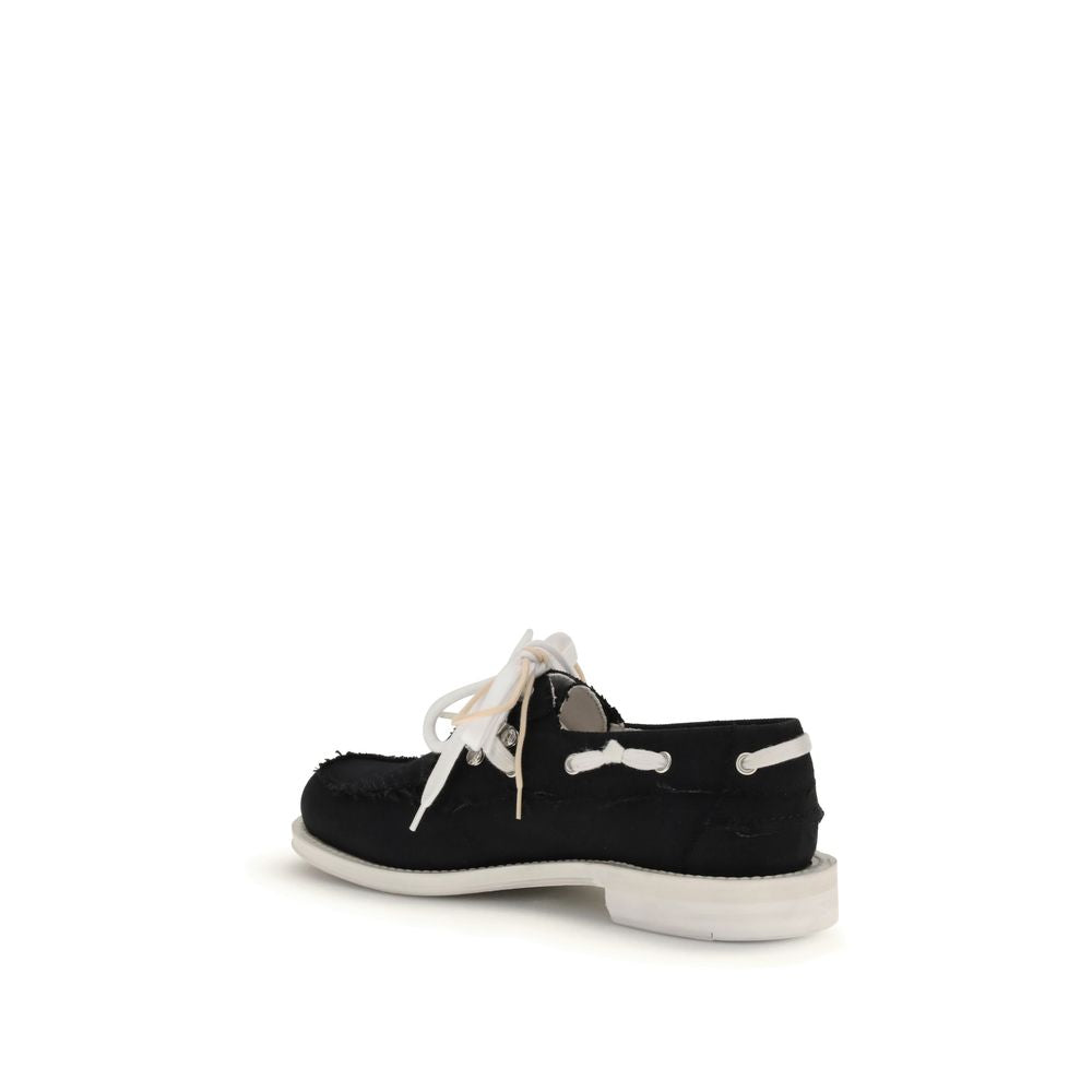 Black Cotton Slip-On LoafersThe Boat Shoes by Dsquared2 combine traditional structure with lightweight materials. Featuring a cotton upper and a white rubber sole, they offer comfort, breathability, and practicality. Ideal for those seeking a relaxed yet