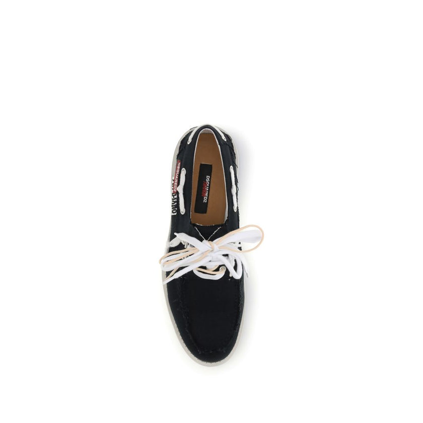 Black Cotton Slip-On LoafersThe Boat Shoes by Dsquared2 combine traditional structure with lightweight materials. Featuring a cotton upper and a white rubber sole, they offer comfort, breathability, and practicality. Ideal for those seeking a relaxed yet